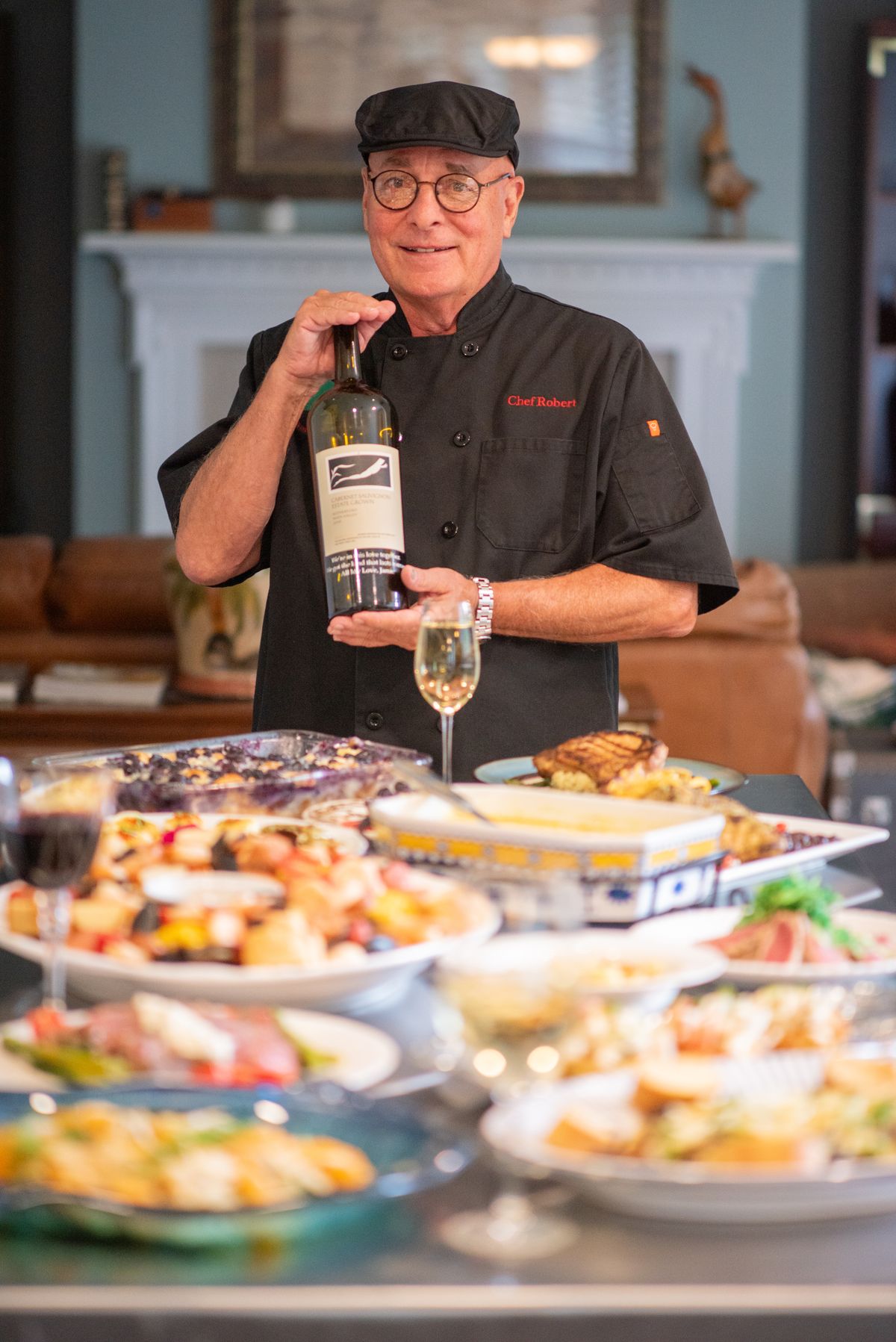 Chef Robert Atchison presenting a spread of catered dishes