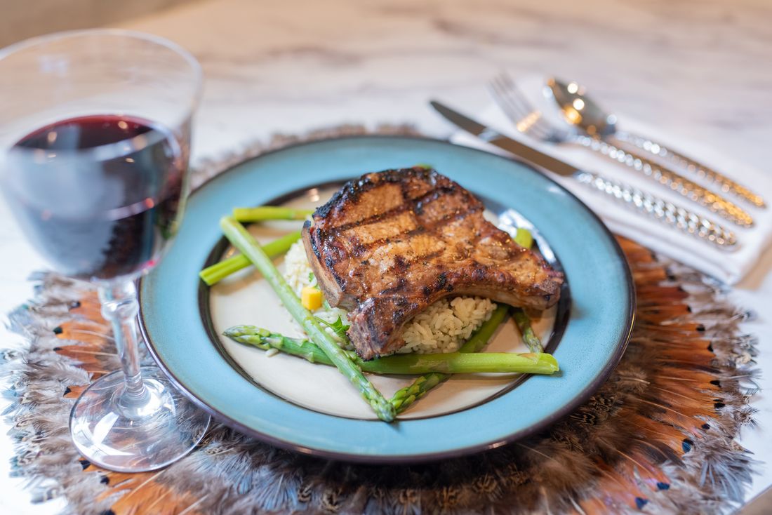 Pineapple teriyaki glazed pork chop on mango cilantro rice with asparagus