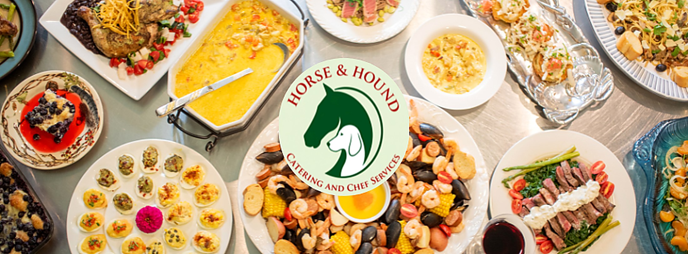 Spread of Horse and Hound catered dishes with the Horse and Hound logo